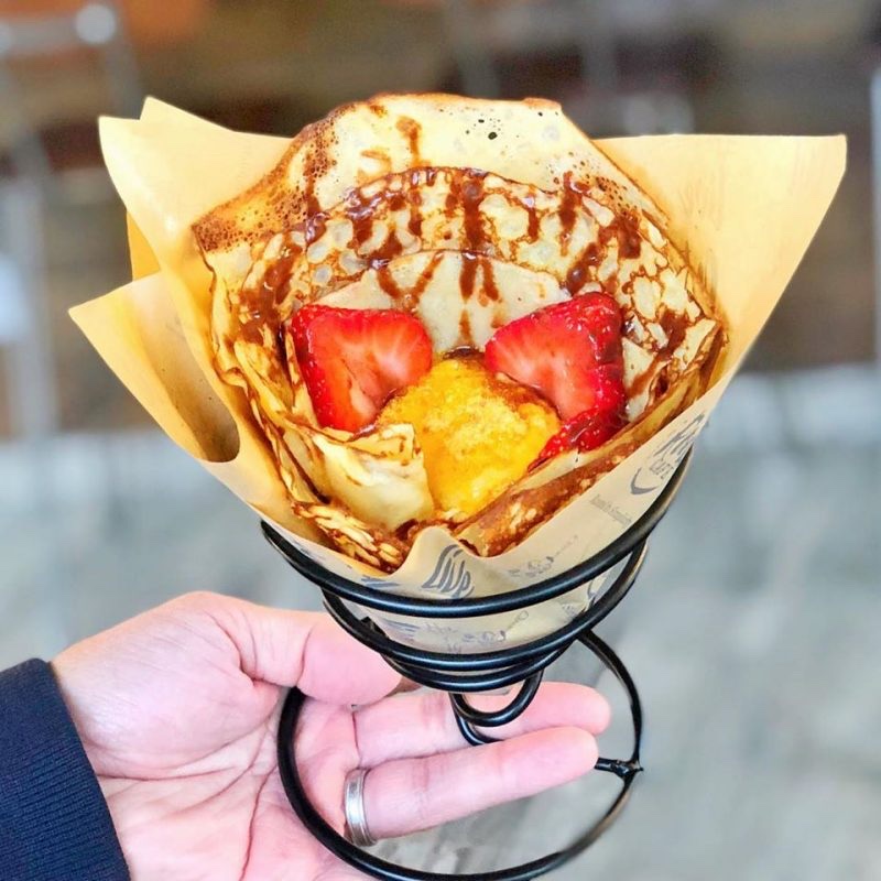 A fresh strawberry crepe cone from Roots Café